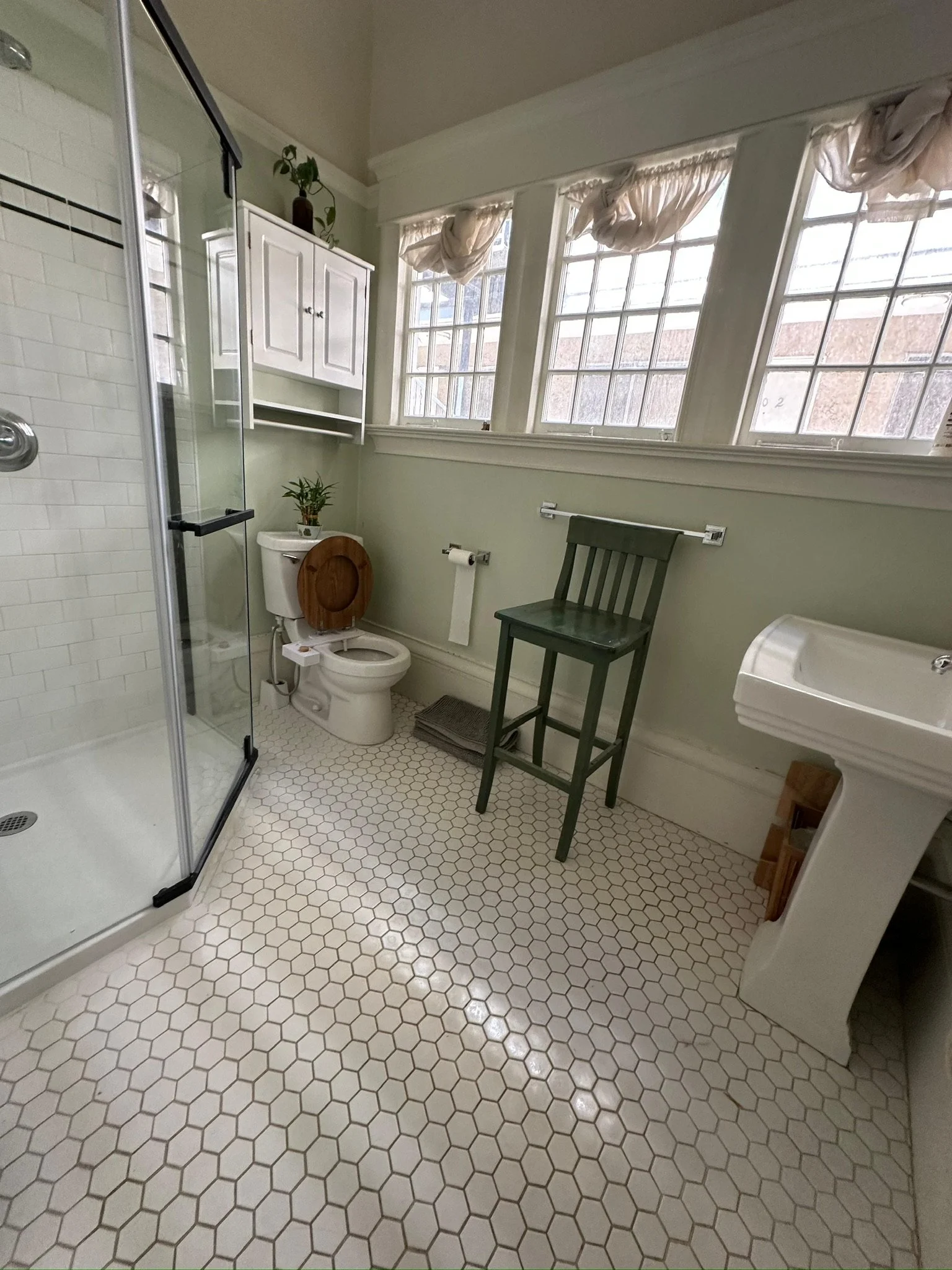 Full bathroom remodel with white subway tile shower, hex tile flooring, pedestal sink, and large windows in Sonoma, CA