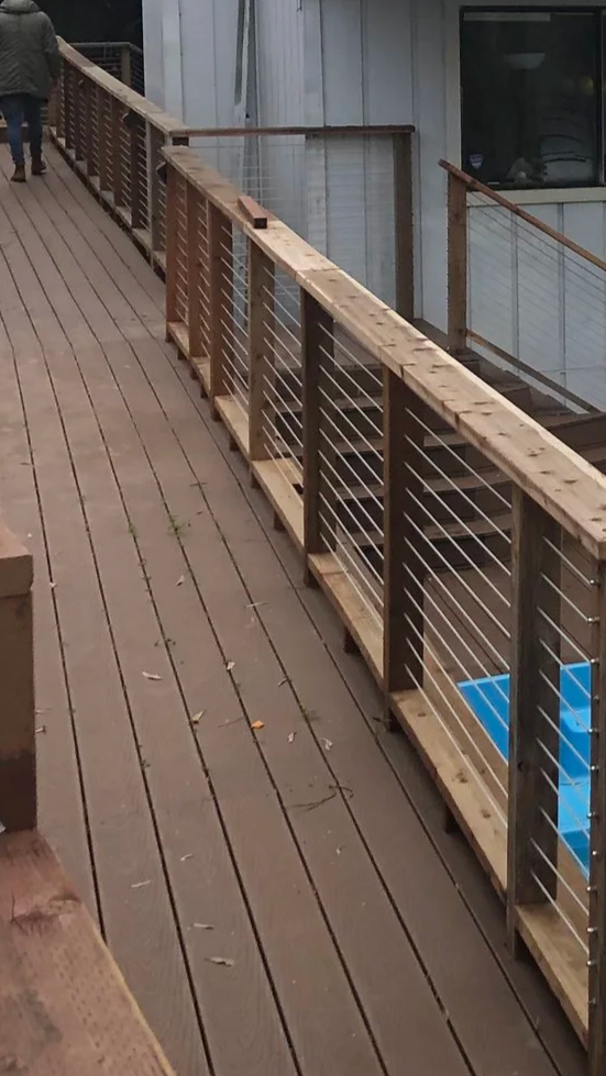 Deck renovation in Marin County including new decking boards, wood handrails, and stainless steel cable railing installation by MF Sanchez Construction & Painting.