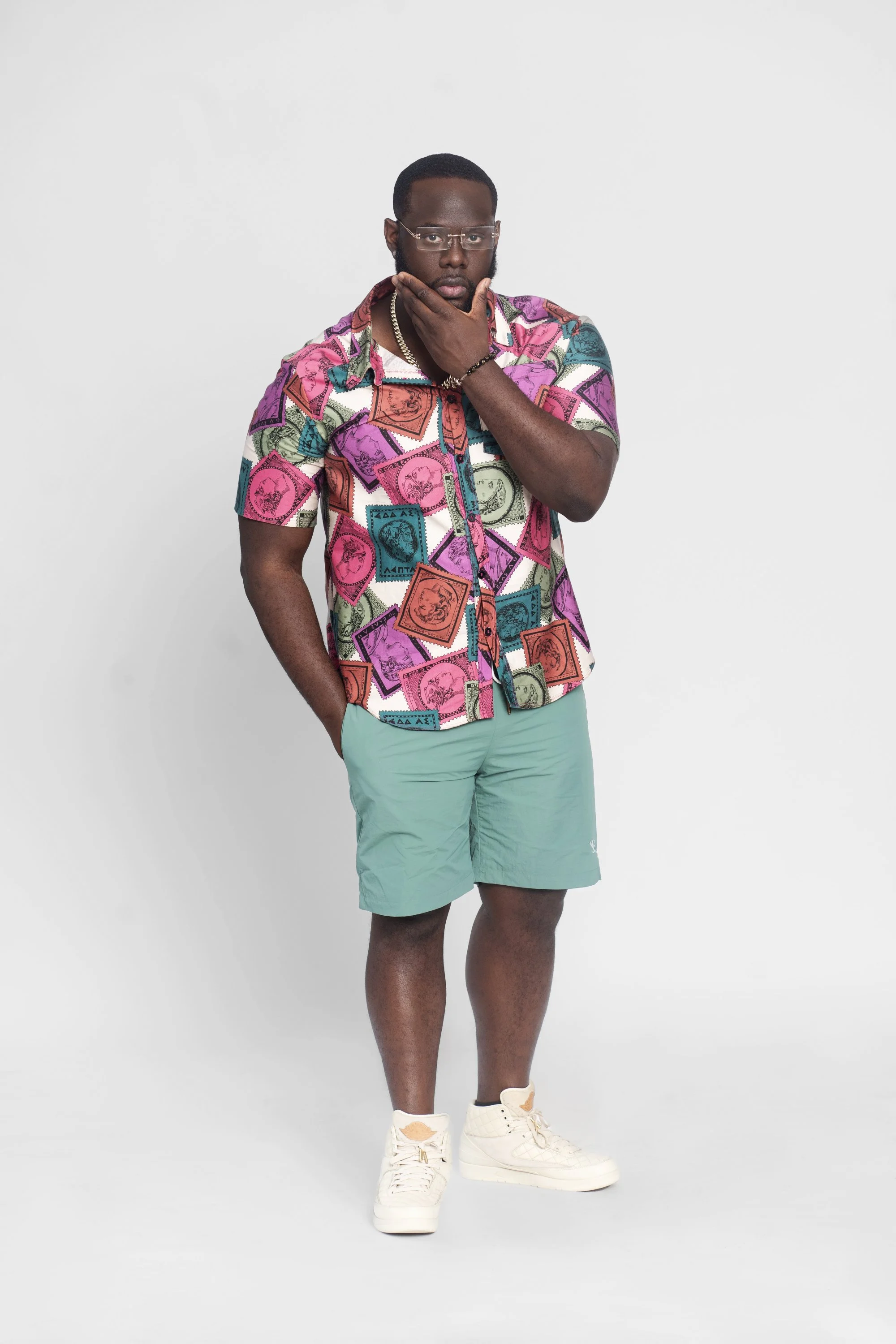 Loon with pink/green multicolor shirt with tel green shorts on white background