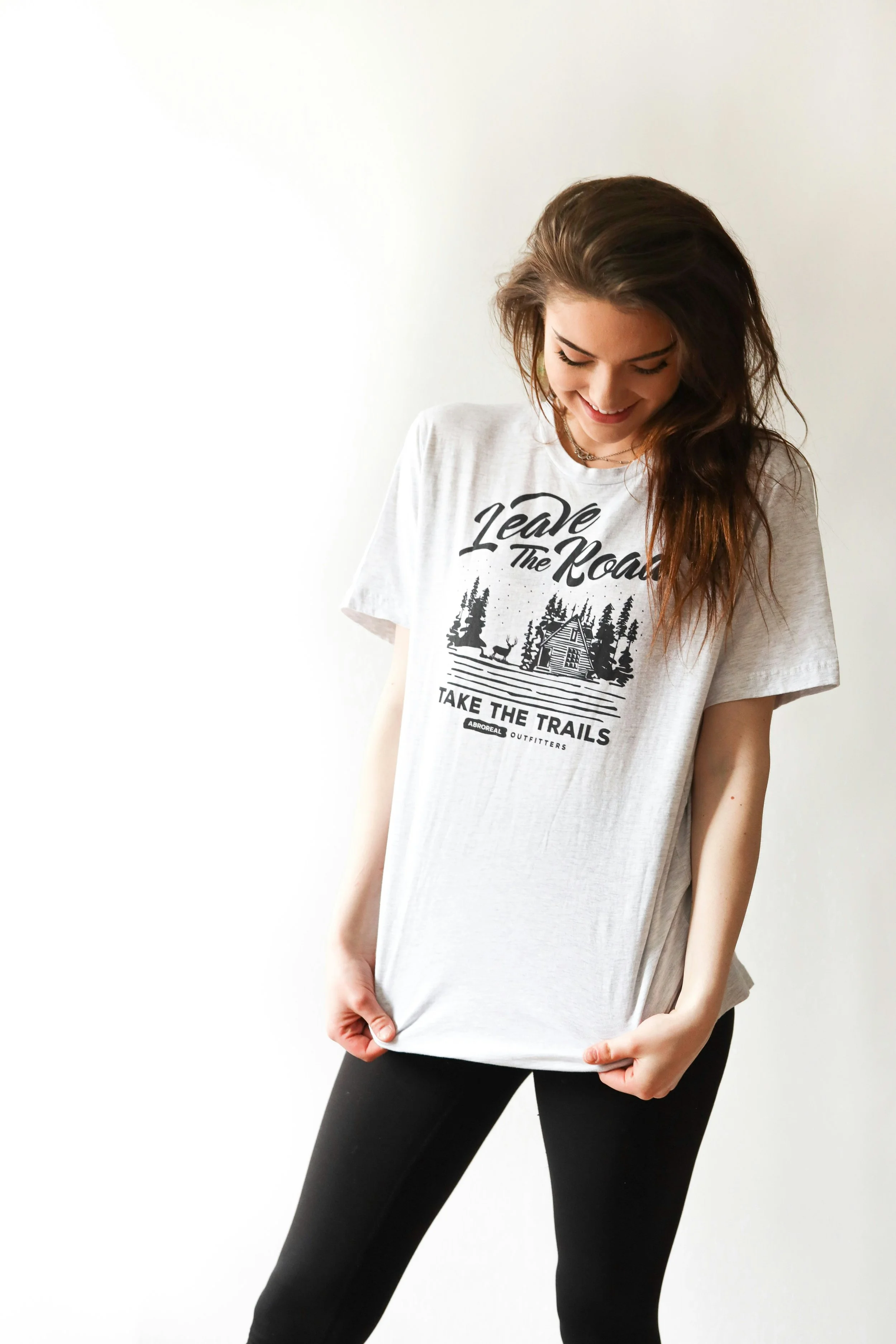 Woman wearing a graphic tee with a forest print