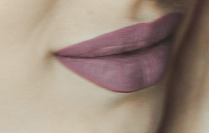 Lips with matte purple lipstick