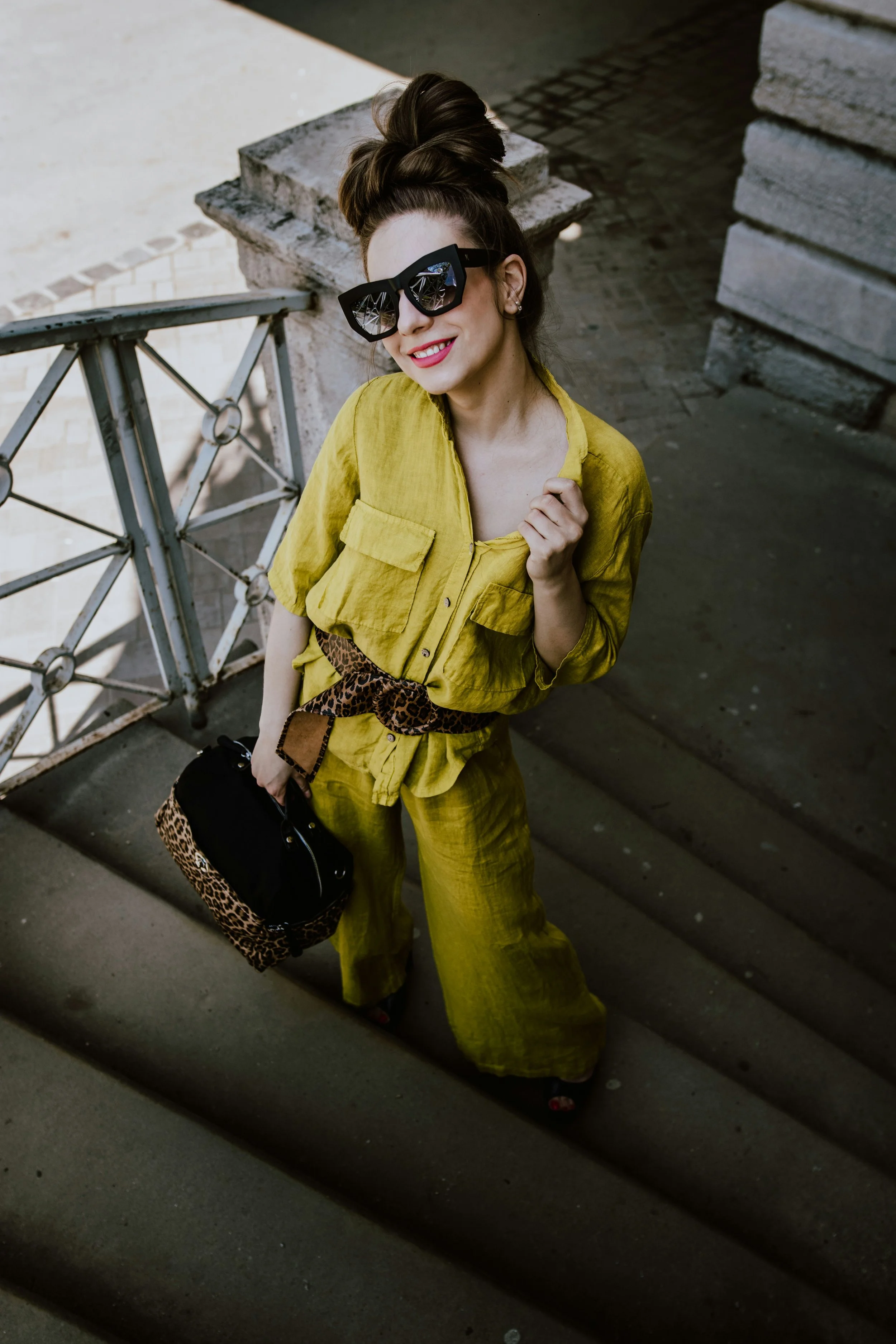 Woman wearing a loose Natural essence top paired with a glamorous Romantic essence belt