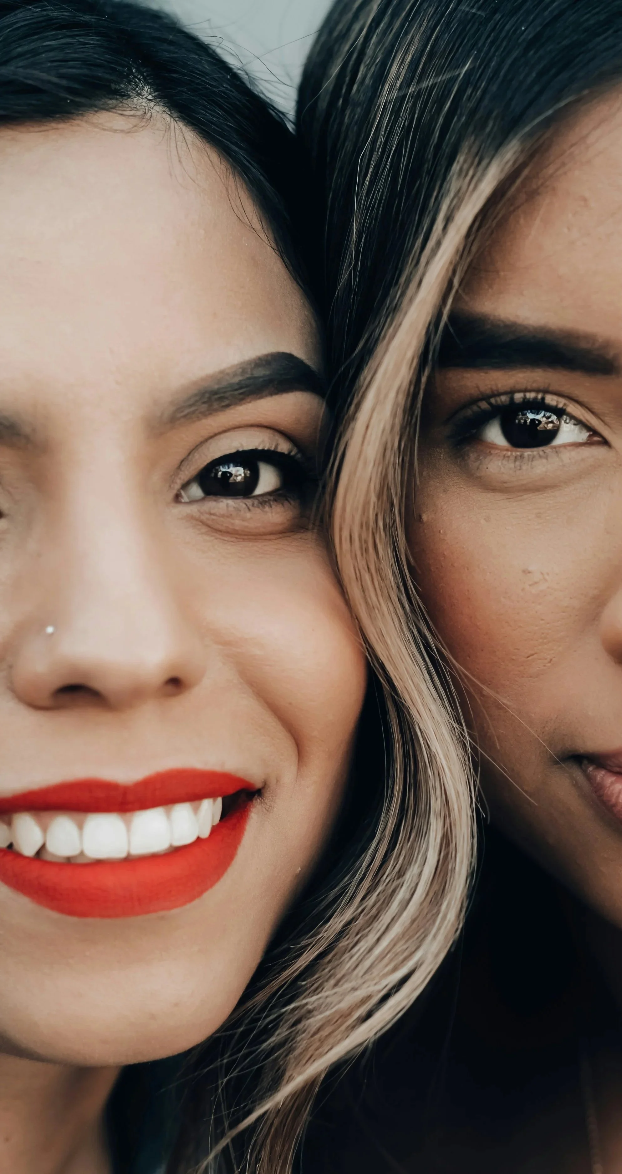 Smiling Hispanic woman wearing orange lipstick that highlights her playful Gamine beauty type