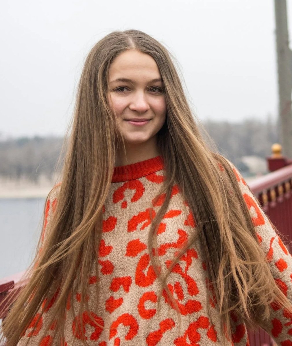 Woman wearing playful orange and beige cheetah print sweater
