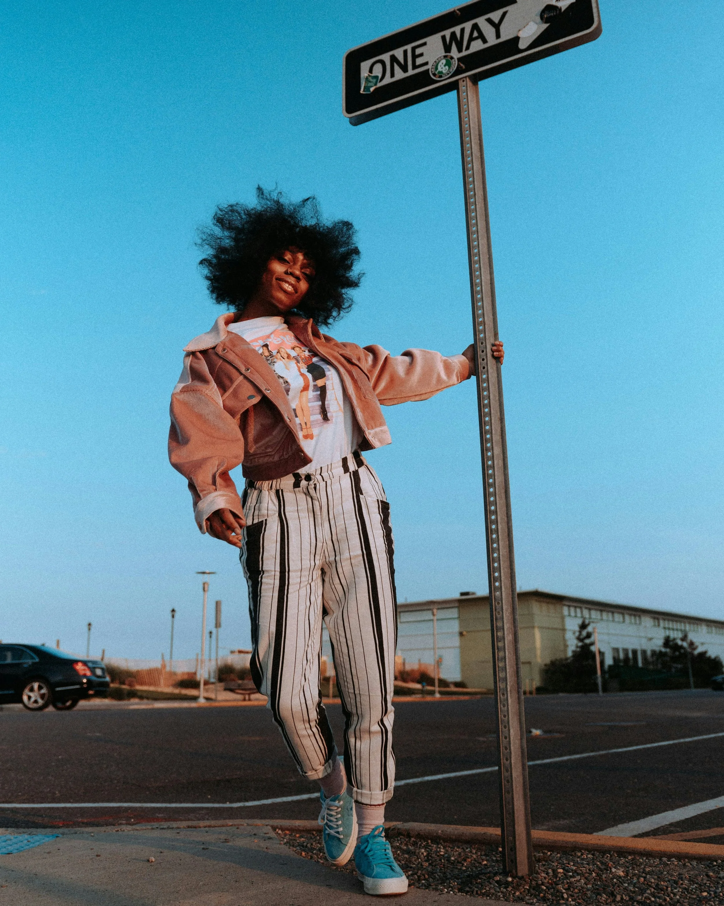 Woman wearing playful outfit including blue sneakers
