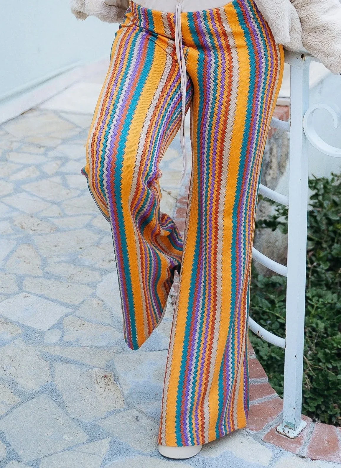 Pants with Gamine chevron in blue, orange, purple, and yellow, embodying playful high-spirited beauty