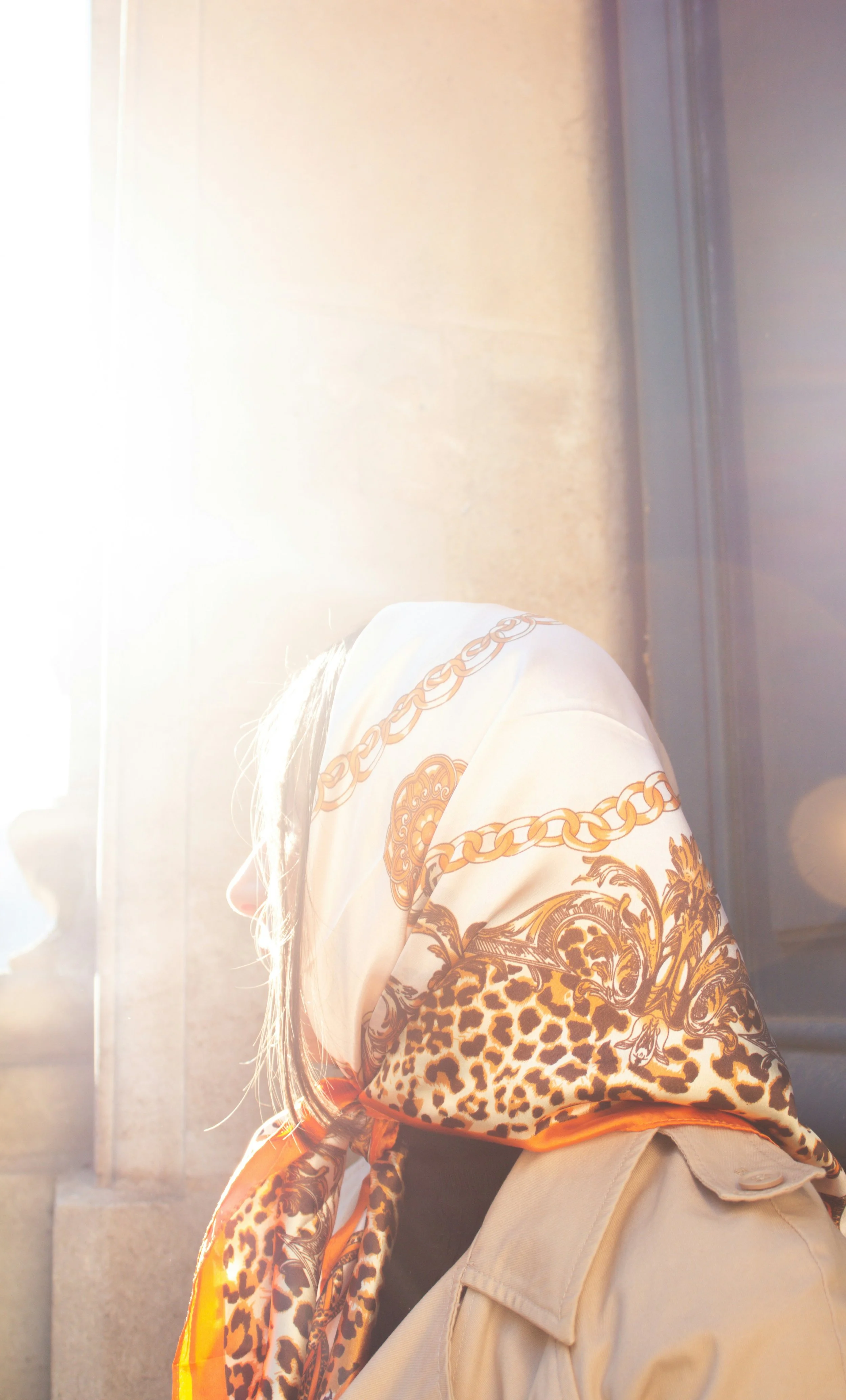 Woman wearing a headscarf featuring chain and leopard print