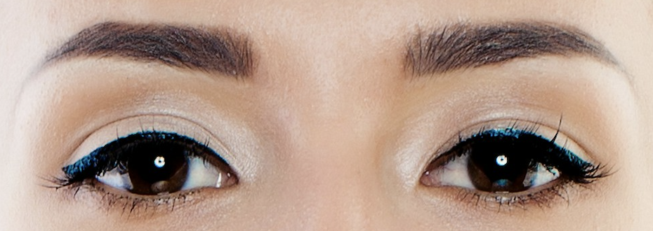 Eyes with dark blue thick Gamine eyeliner with short wings