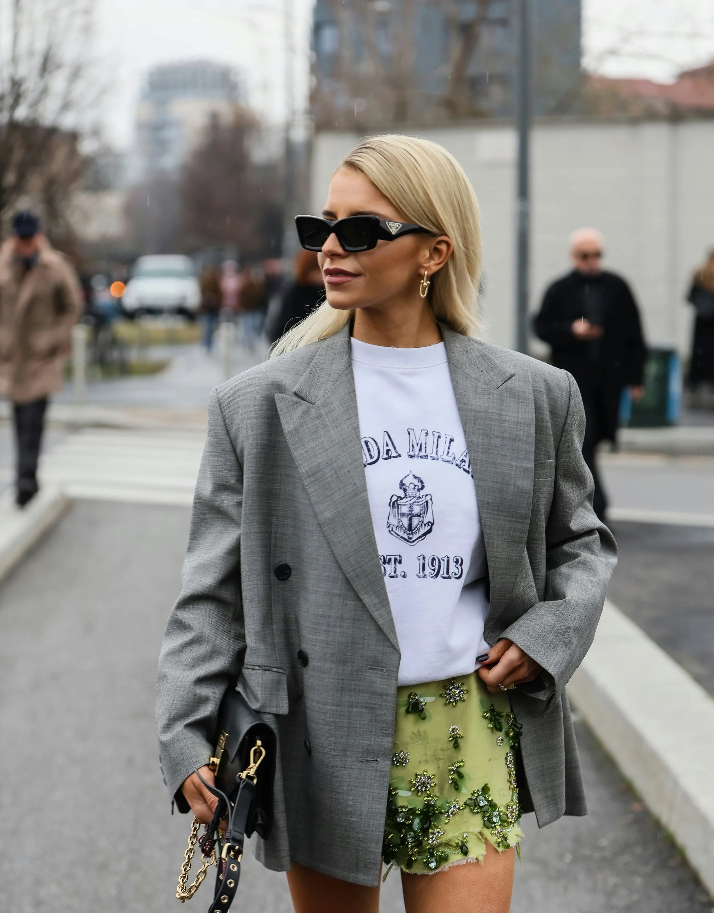 Woman wearing a plaid Classic blazer paired with a graphic Gamine tee