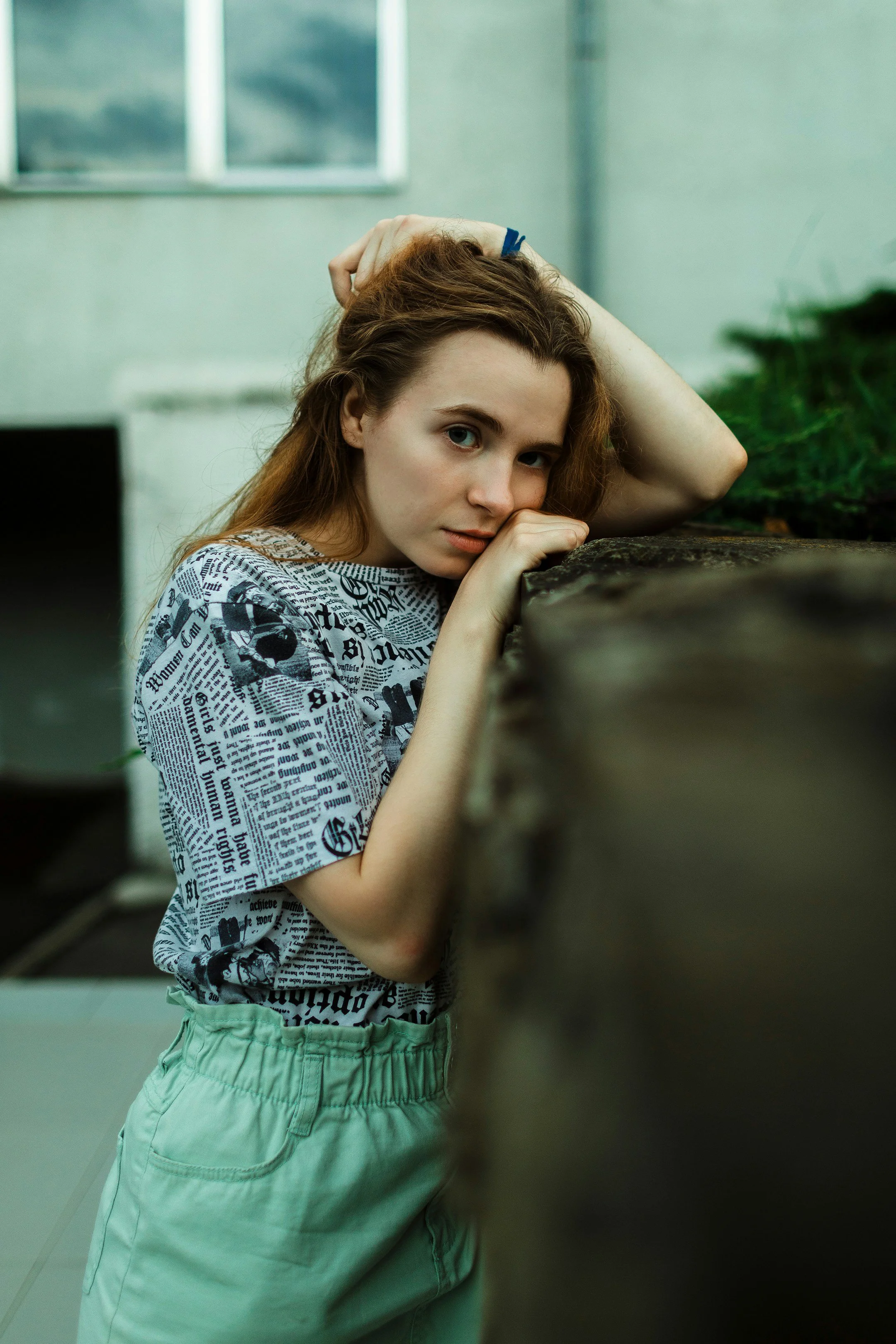 Woman wearing a top featuring a black and white newspaper print