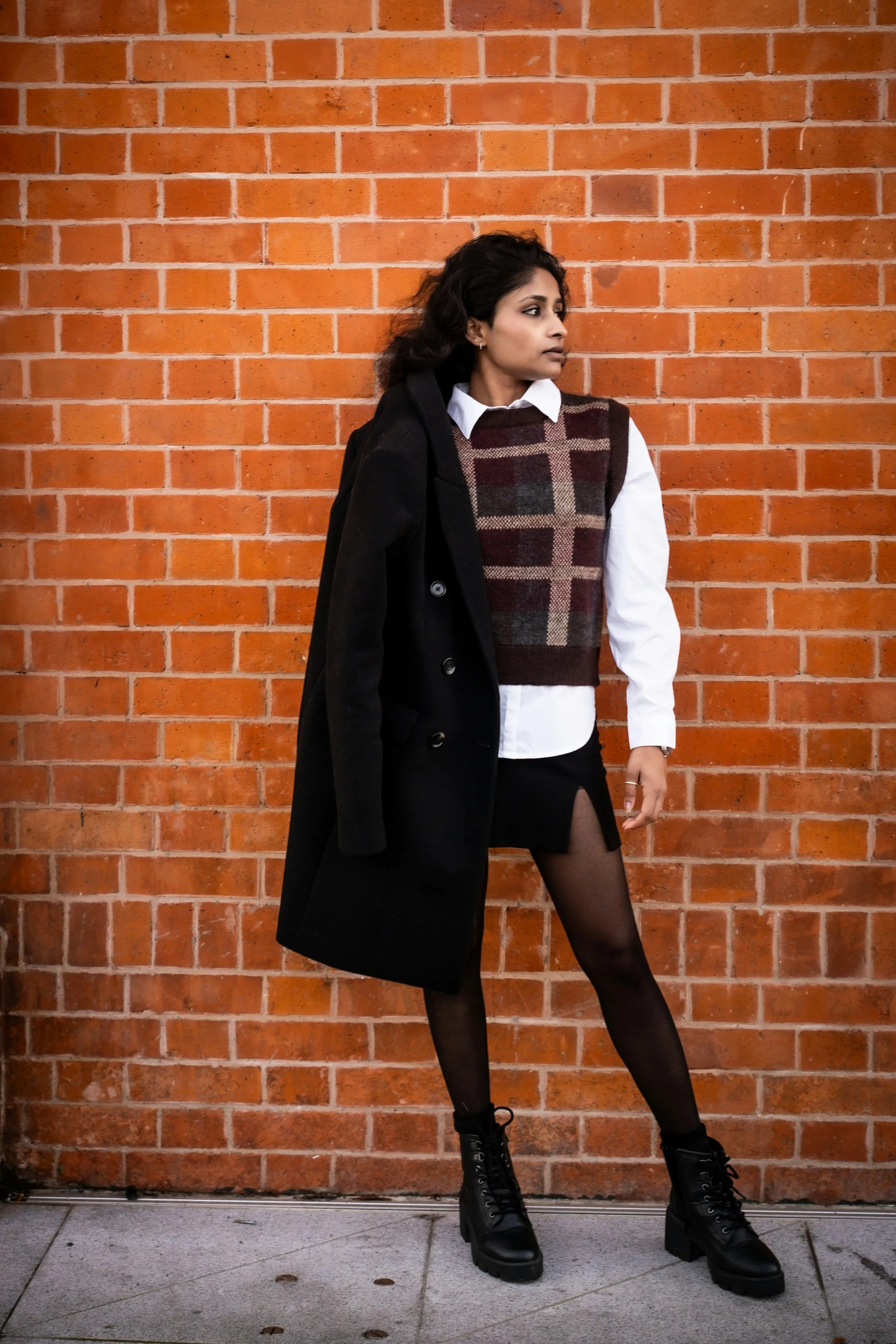 Woman wearing a sweater with oversized plaid