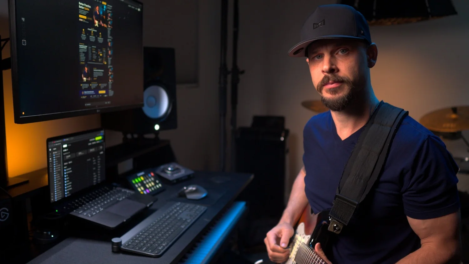 Garrett Ortego with a focused expression, guitar in hand
