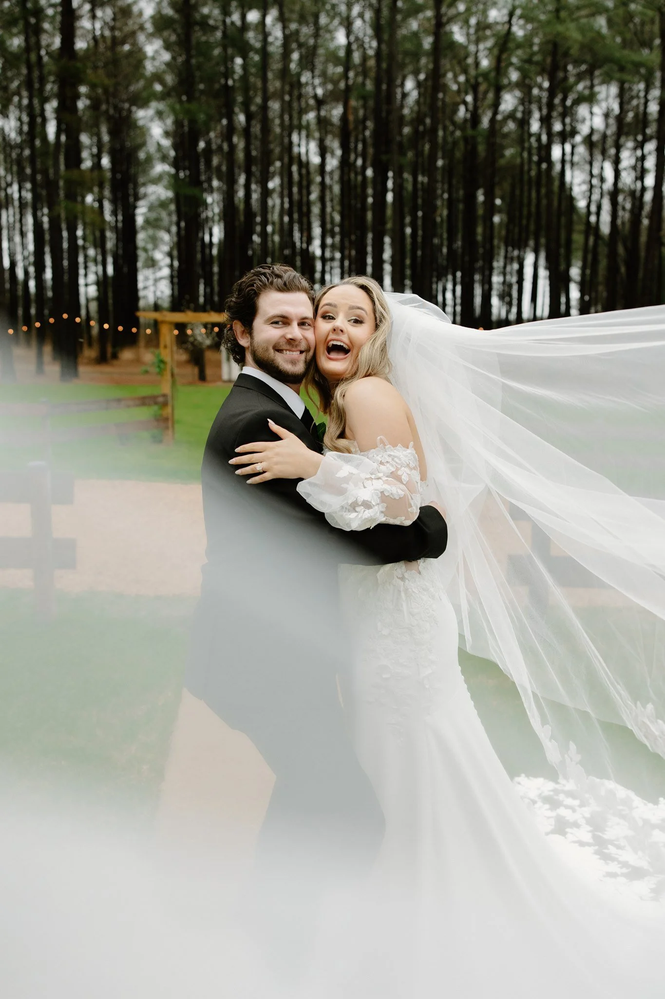 Bride and groom showing candid moments with laughter, at Barn & Bin in Starkville, Mississippi