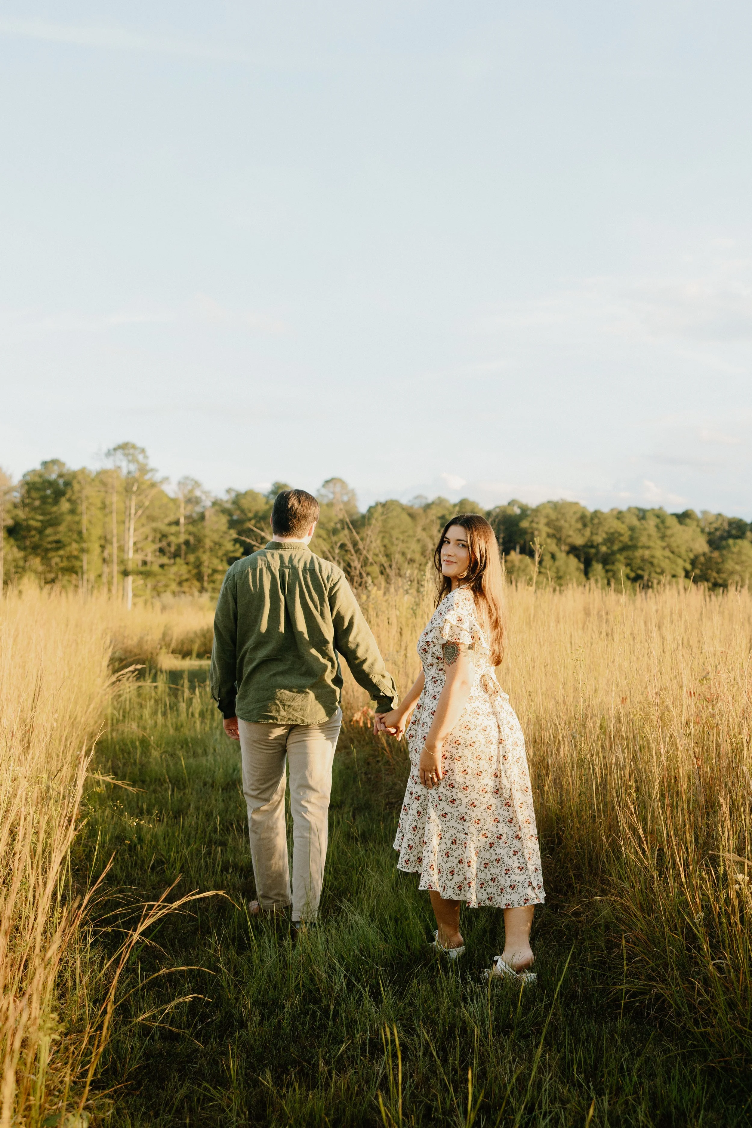 Couple walking away together during engagement portraits done at Refuge outside Starkville, Mississippi.