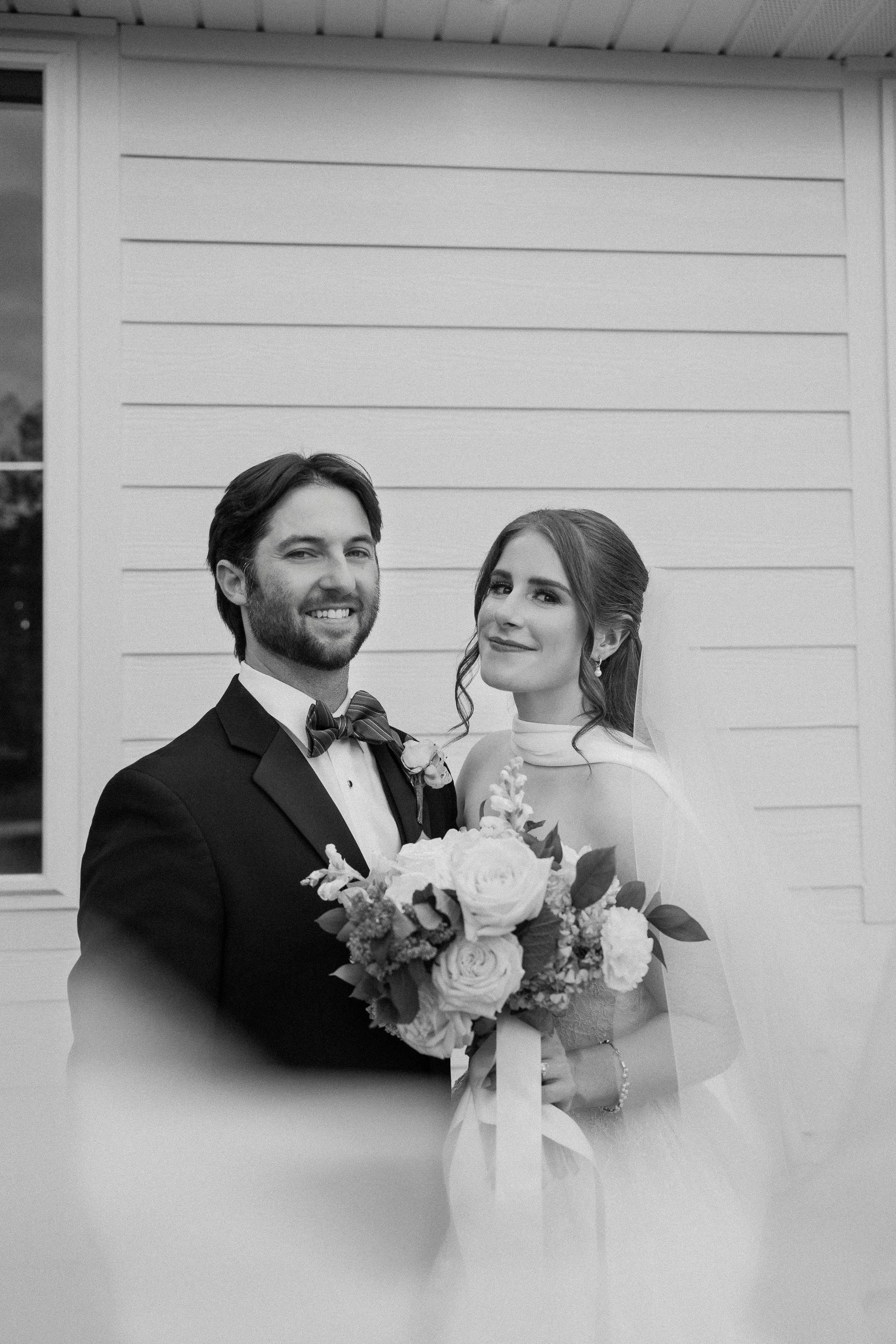 Bride and groom take veil portrait shot outside Kingfisher venue.