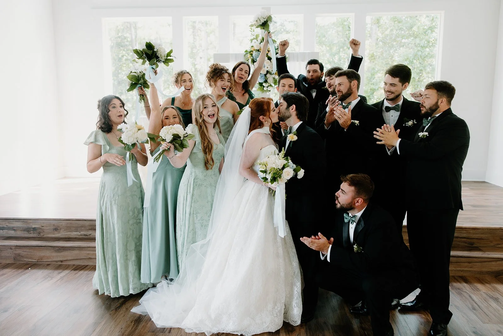 Wedding party celebrating the newlyweds inside Chapel at Kingfisher in Tupelo, Mississippi.
