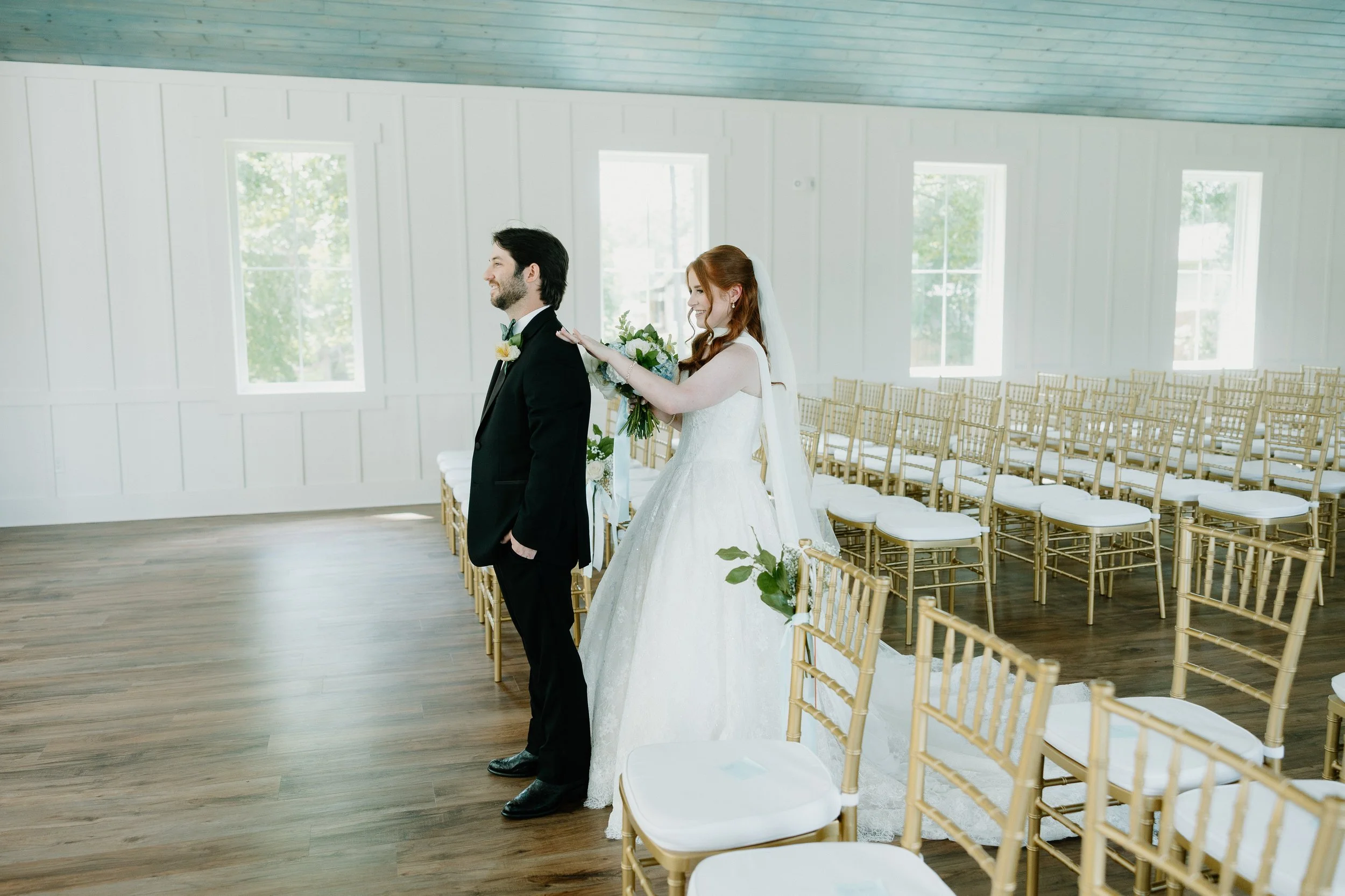 Bride and groom have their first look in the Chapel at Kingfisher Lodge