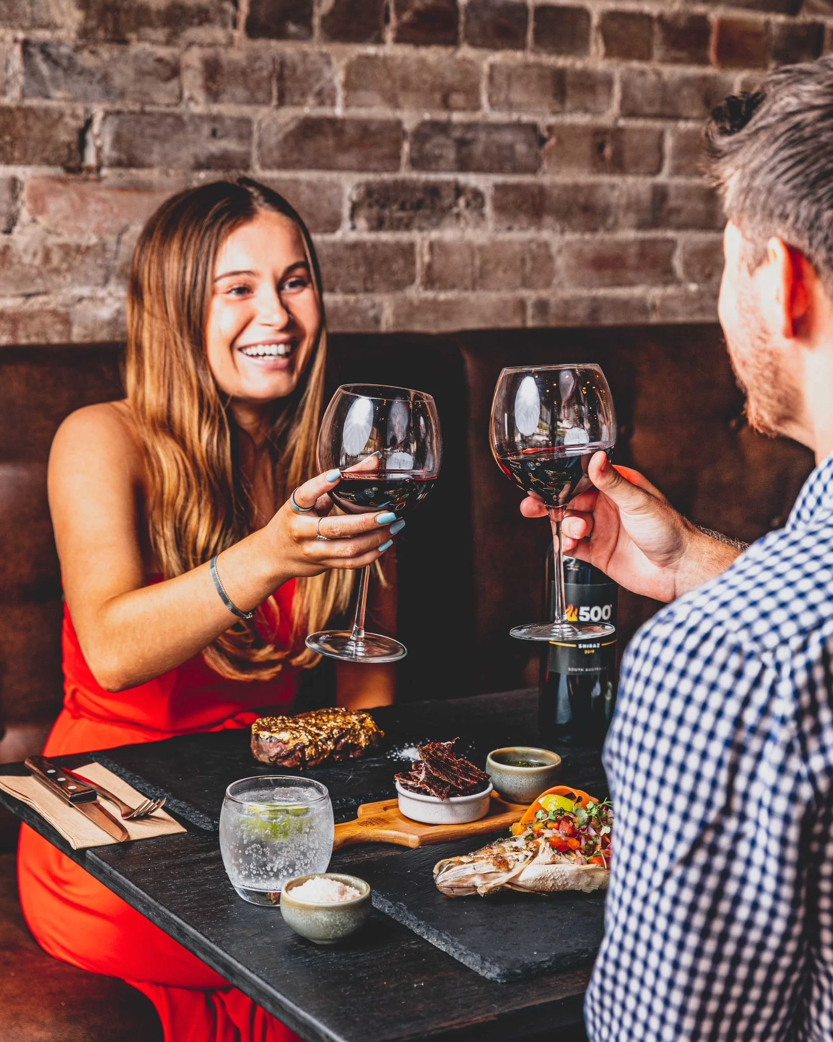 Couple enjoying wine and sharing a meal at a restaurant
