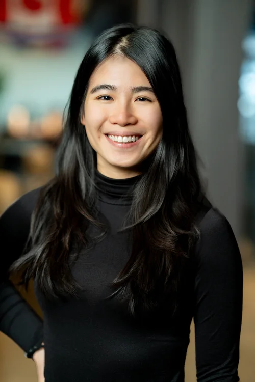 Team headshot of a woman in a black turtleneck at a San Francisco tech office