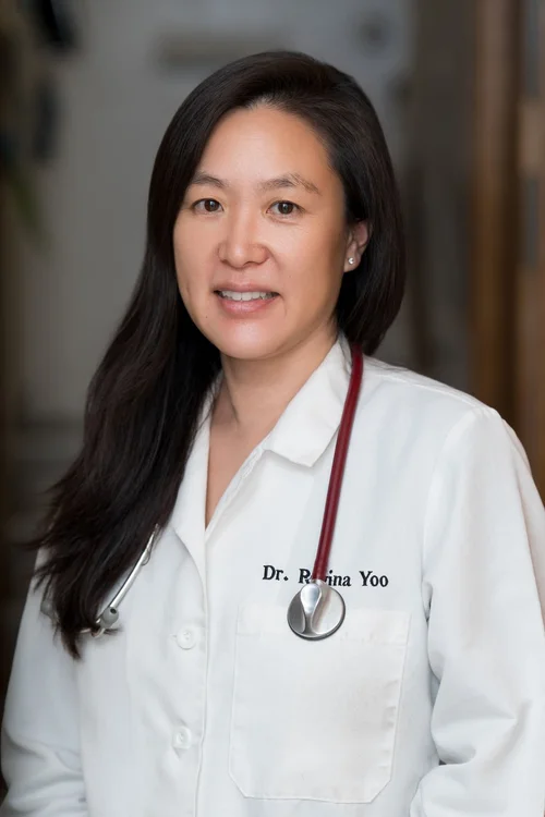Team headshot of a veterinarian in a white coat at a Berkeley vet clinic