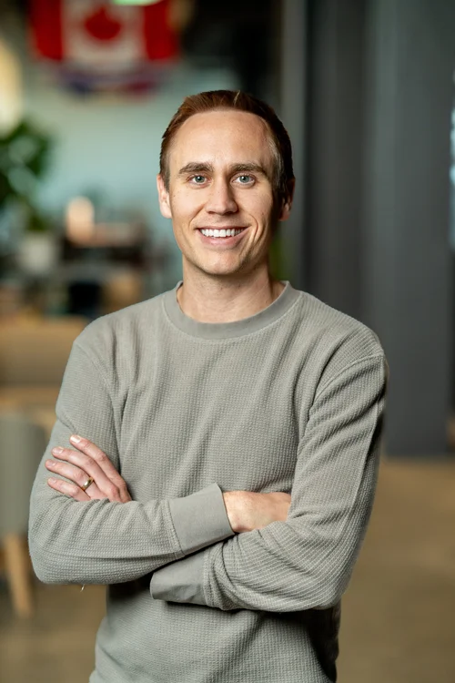 Team headshot of a man in a gray sweater at a San Francisco tech office