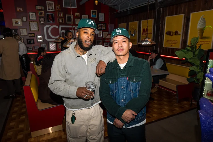Two guests posing at a Chain brand event