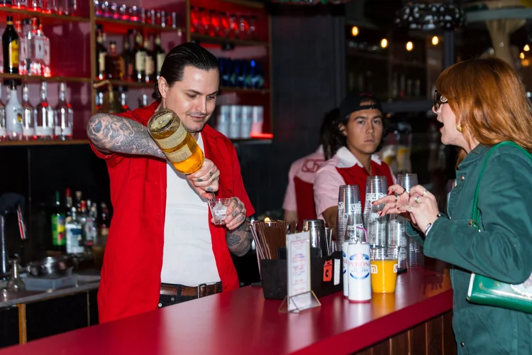 Bartender pouring a cocktail for guests at a Chain brand event