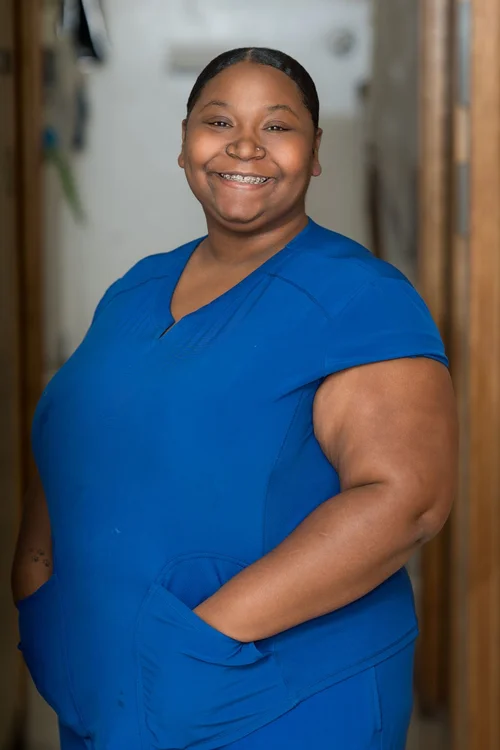 Team headshot of a veterinary technician in blue scrubs at a Berkeley vet clinic