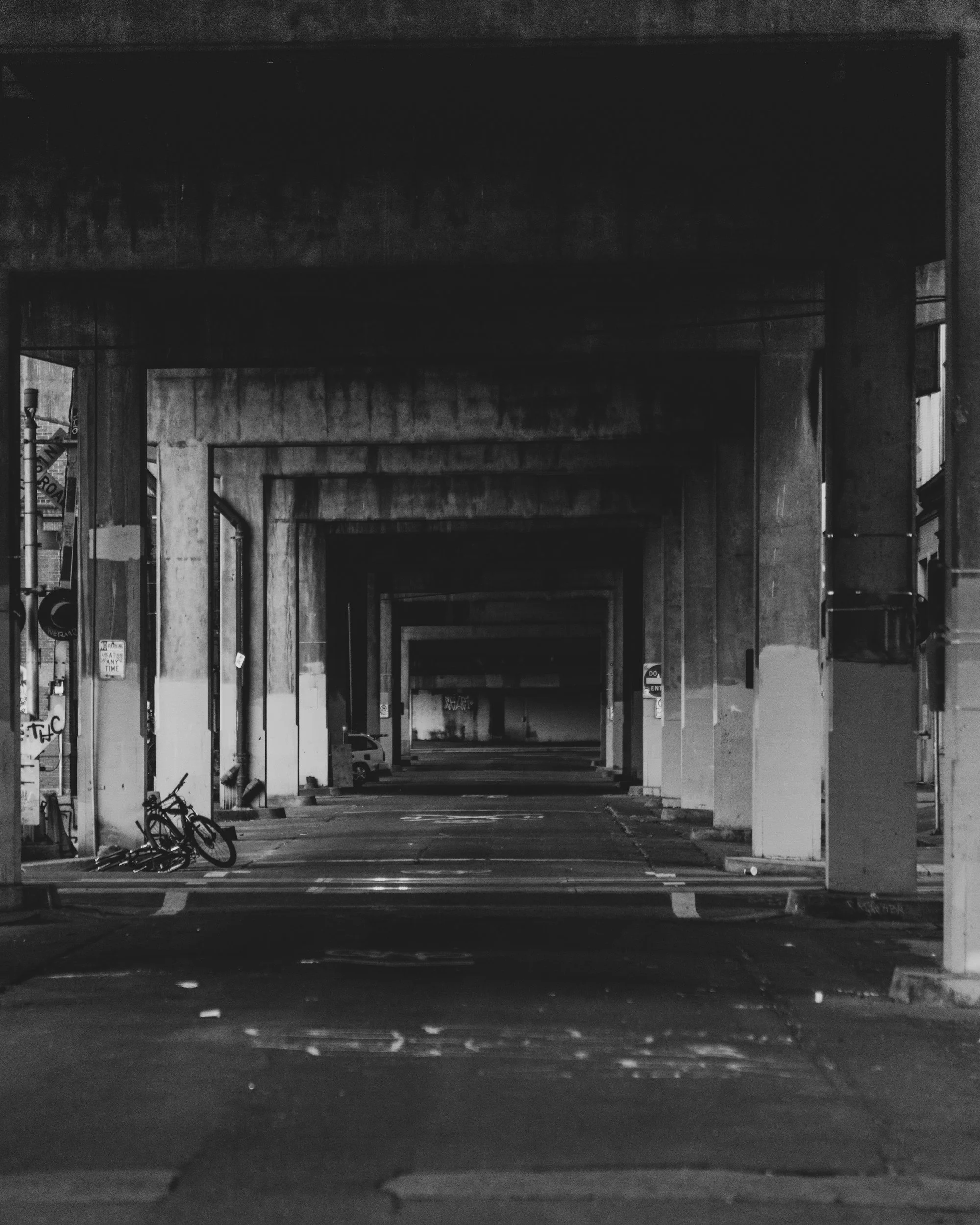 An image of an empty breezeway with abandoned bicycles