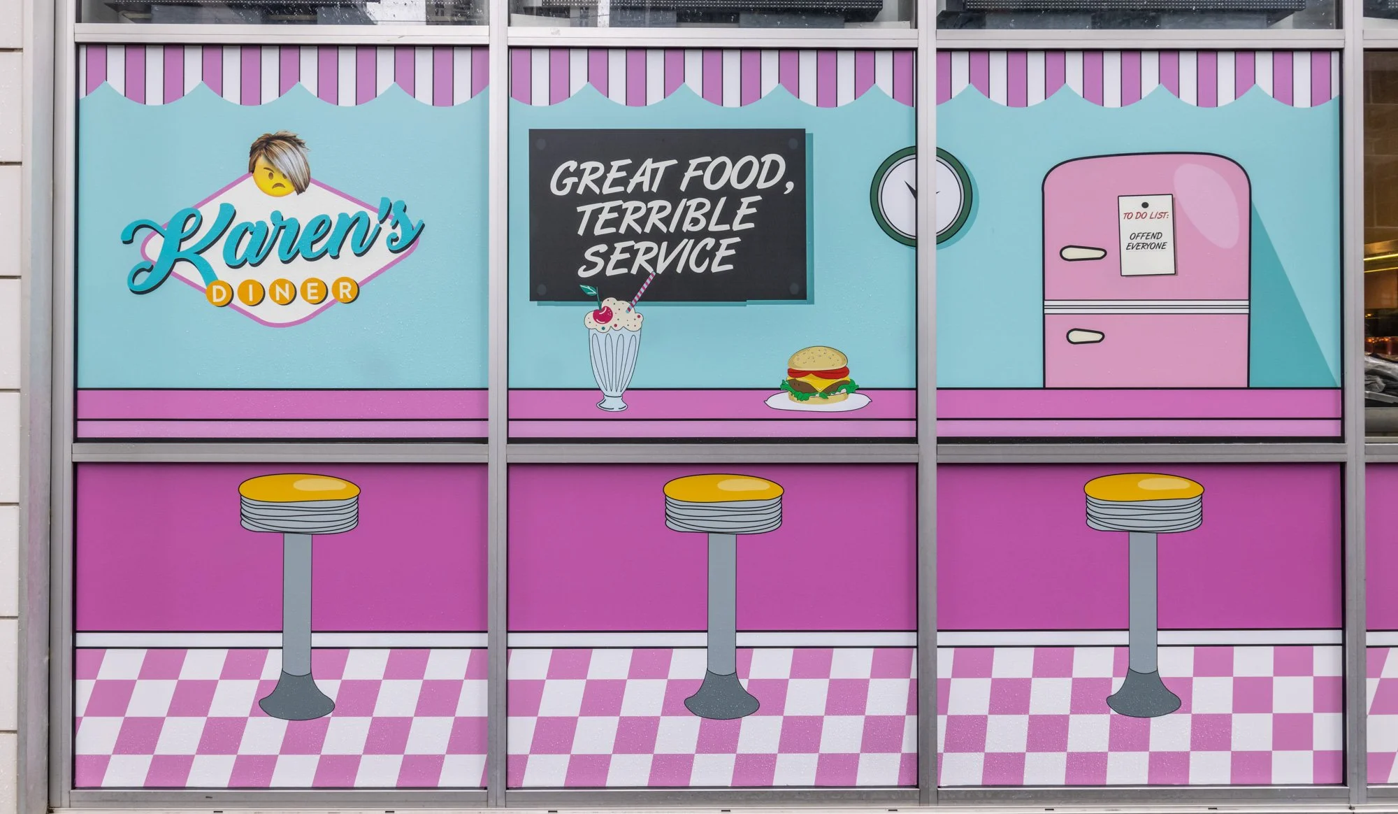 Colorful illustration of Karen's Diner with a pink and blue color theme, featuring a chalkboard sign that says 'Great Food, Terrible Service,' a milkshake, a burger, a purple refrigerator with a note that says 'To Do List: Offend Everyone,' and three