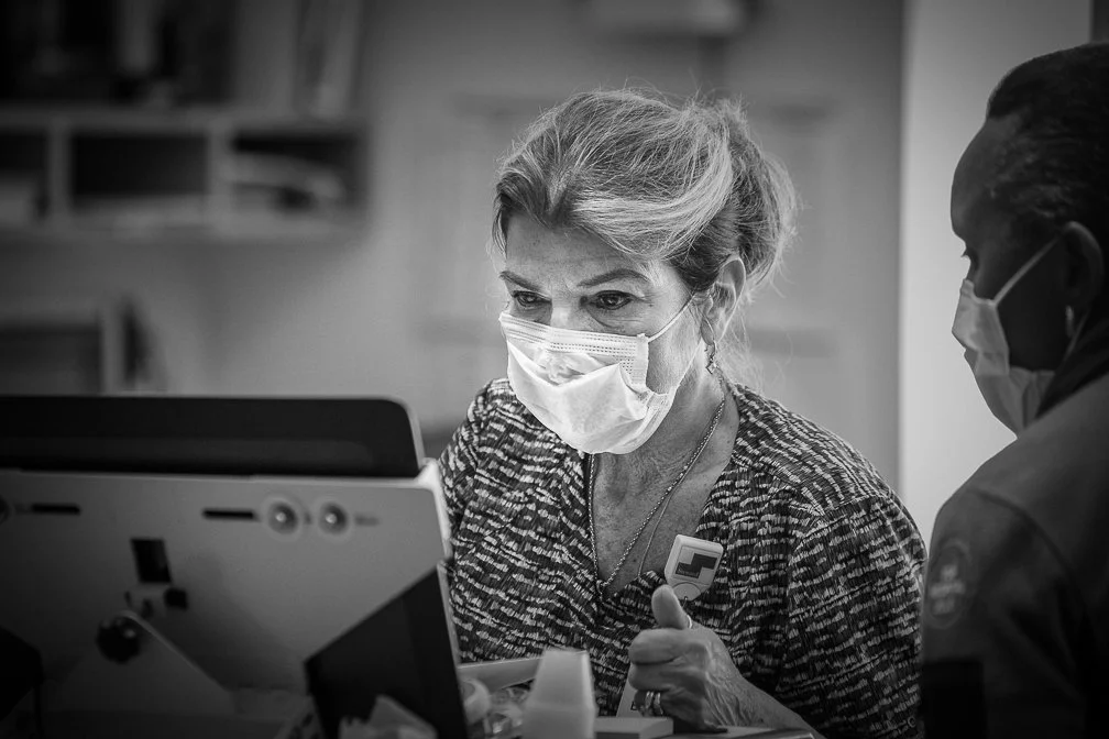 A nurse and doctor intently gather patient info at a nurse station computer during the height of the Covid epidemic.