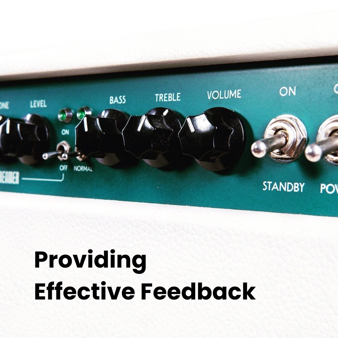 close up of buttons on a teal and white amplifier