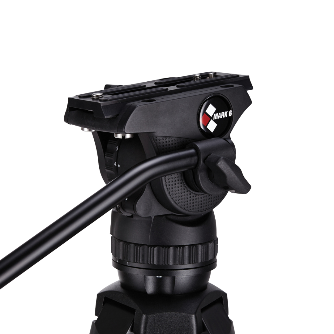 Close-up of a black multipart camera tripod head with a panoramic scale and a marking dial, labeled 'Mark 6'.