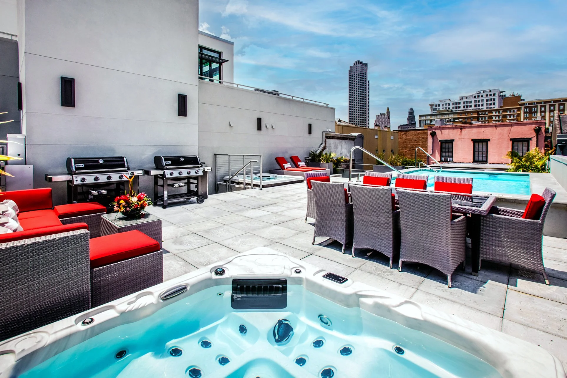 Rooftop deck with hot tub, lounge seating, grills and pool at The Residences at 917 Conti