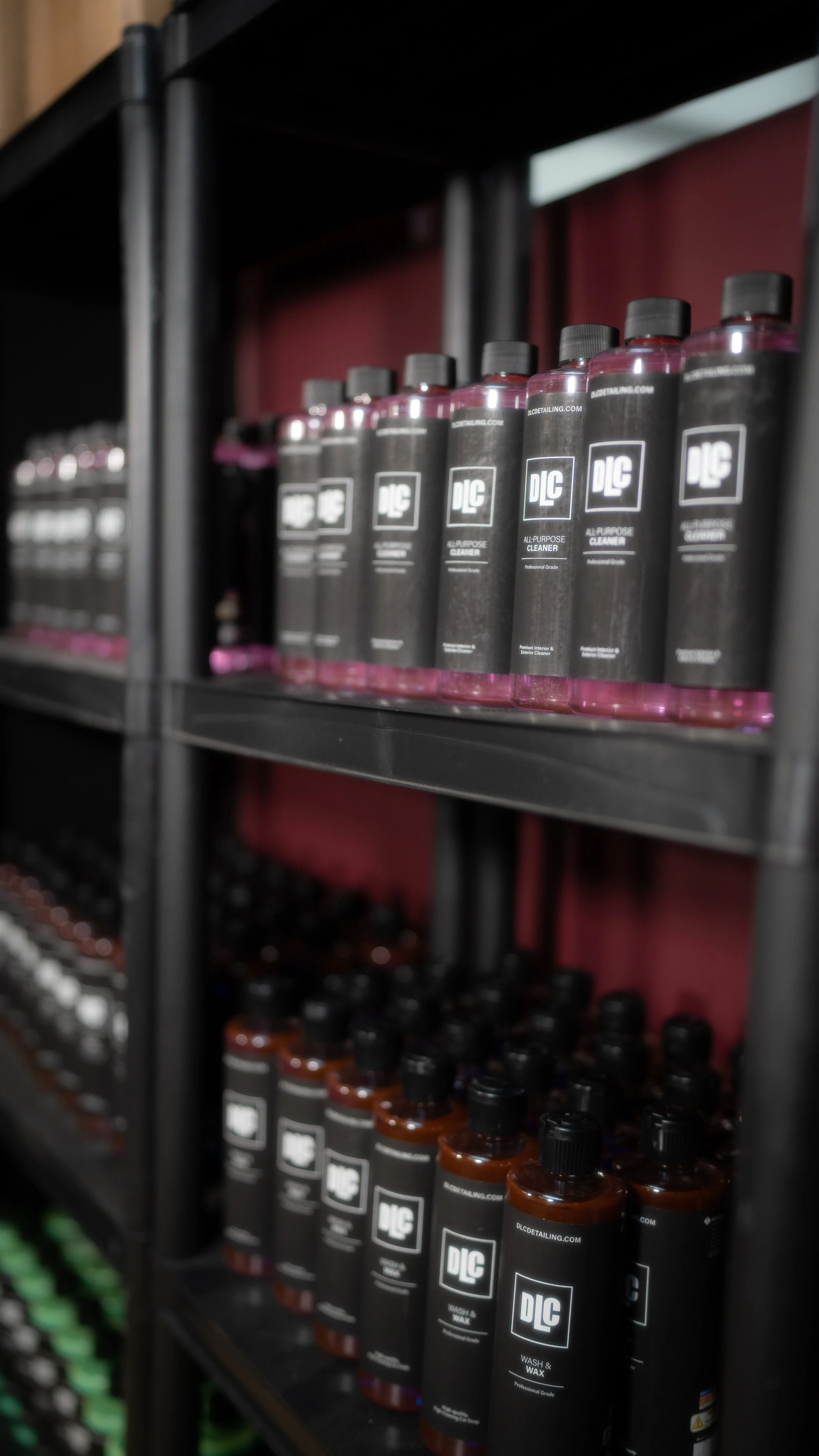 Shelves stocked with bottles of DLC brand all-purpose cleaner and wash & wax products.