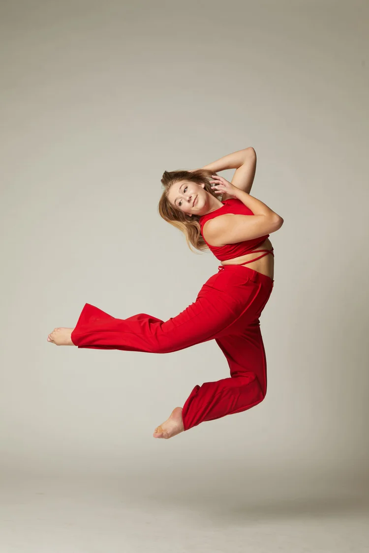 Sarah Childs jumping in a red two-piece