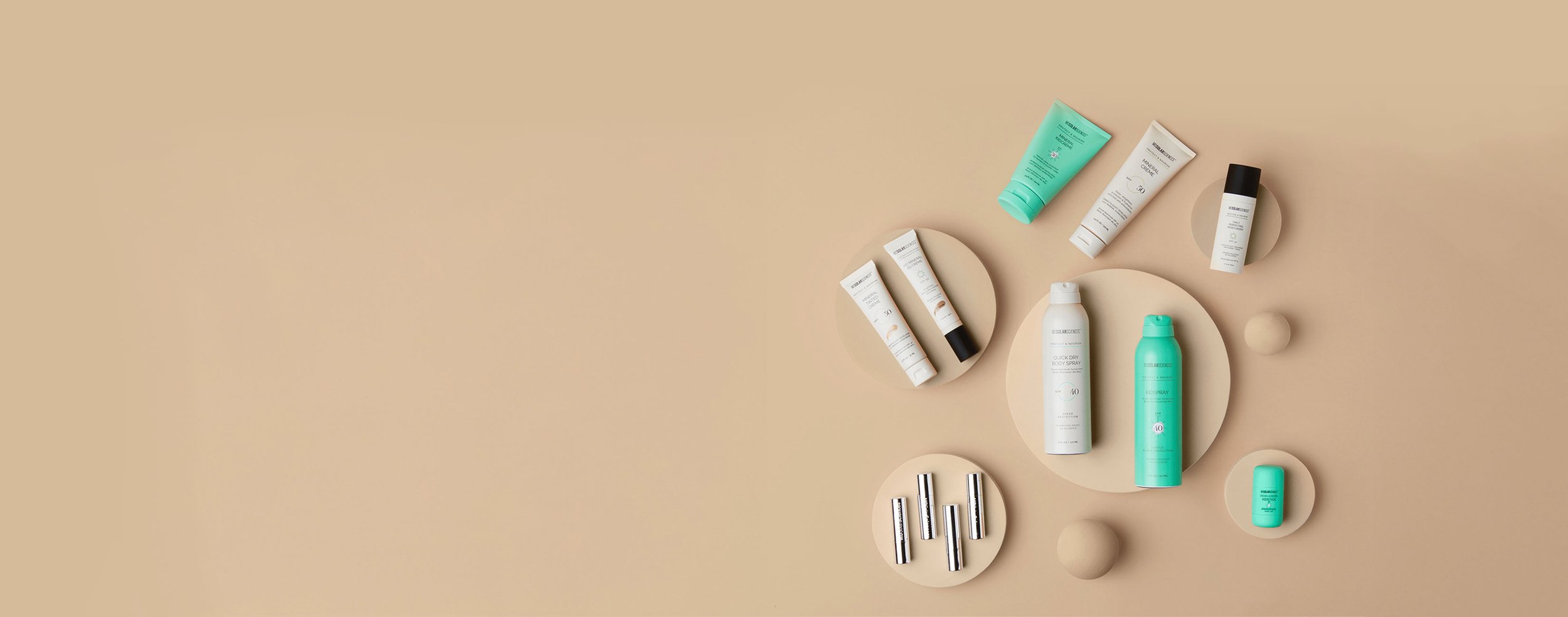 Cosmetics arranged on modern sand-colored plates