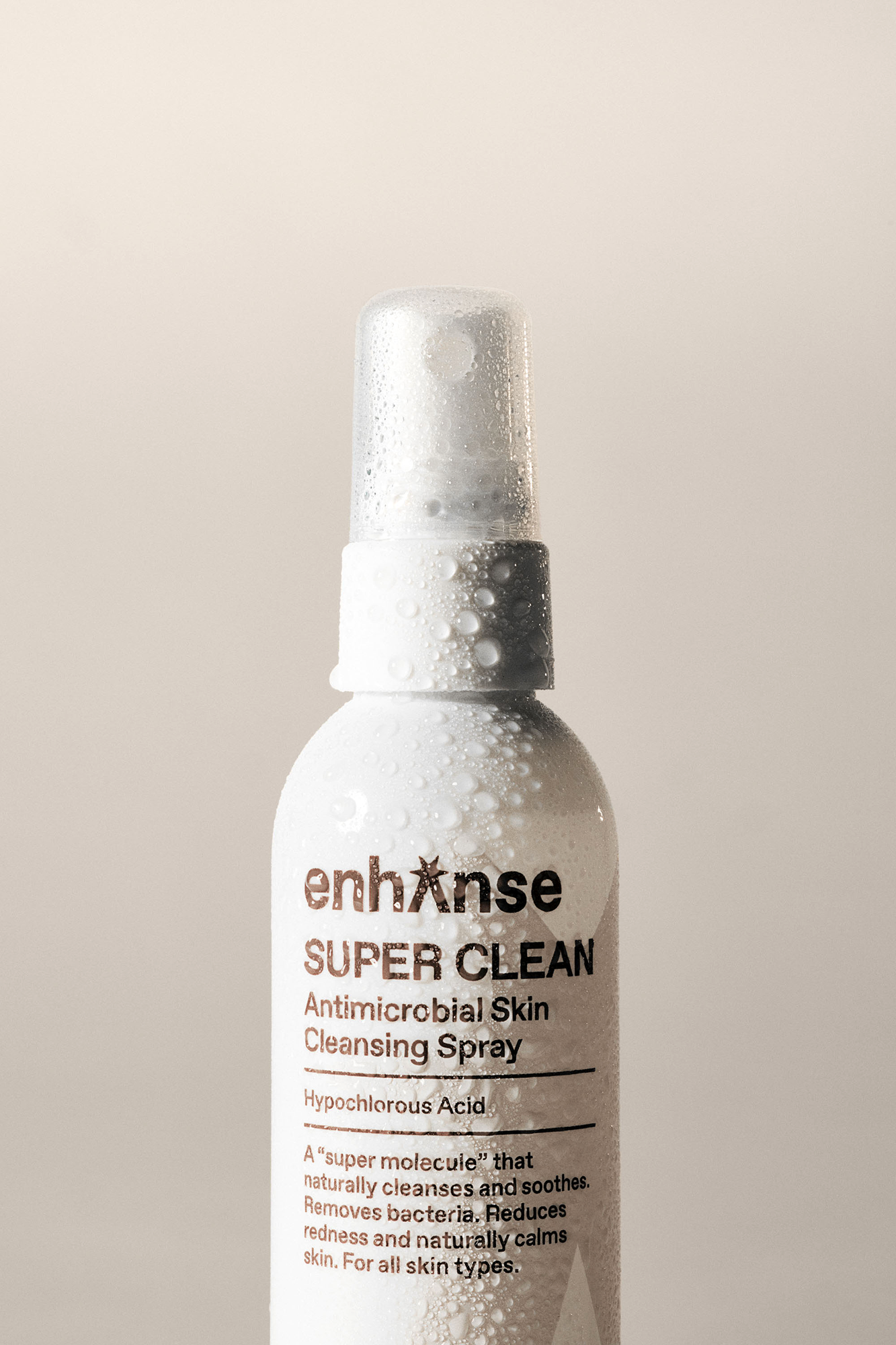 Enhanse Super Clean antimicrobial skin cleansing spray with hypochlorous acid — natural facial mist that removes bacteria, calms redness, and soothes sensitive skin, shot by Hyperblack Studios c