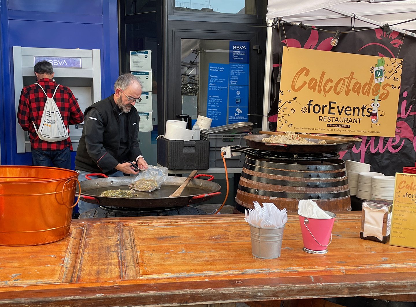 Vendor getting a rice dish ready for heating.
