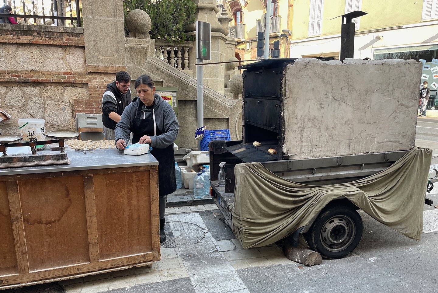 Vendor of freshly baked bread with sausages inside
