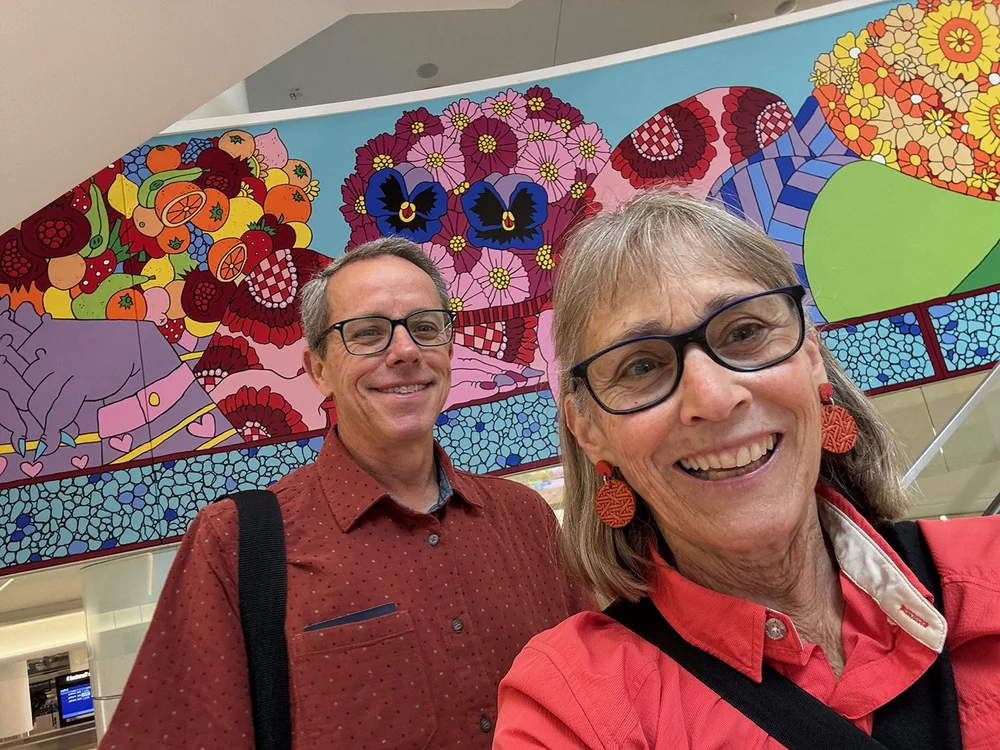   At SFO, in front of the mural our friend Ellen painted on.  