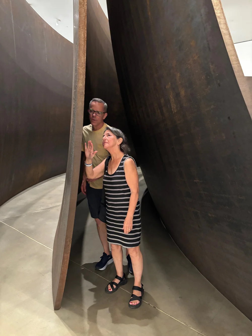 Contemplating the delicate crackling details of the Cor10 steel masterpiece by Richard Serra. Titled “Matter of Time.”