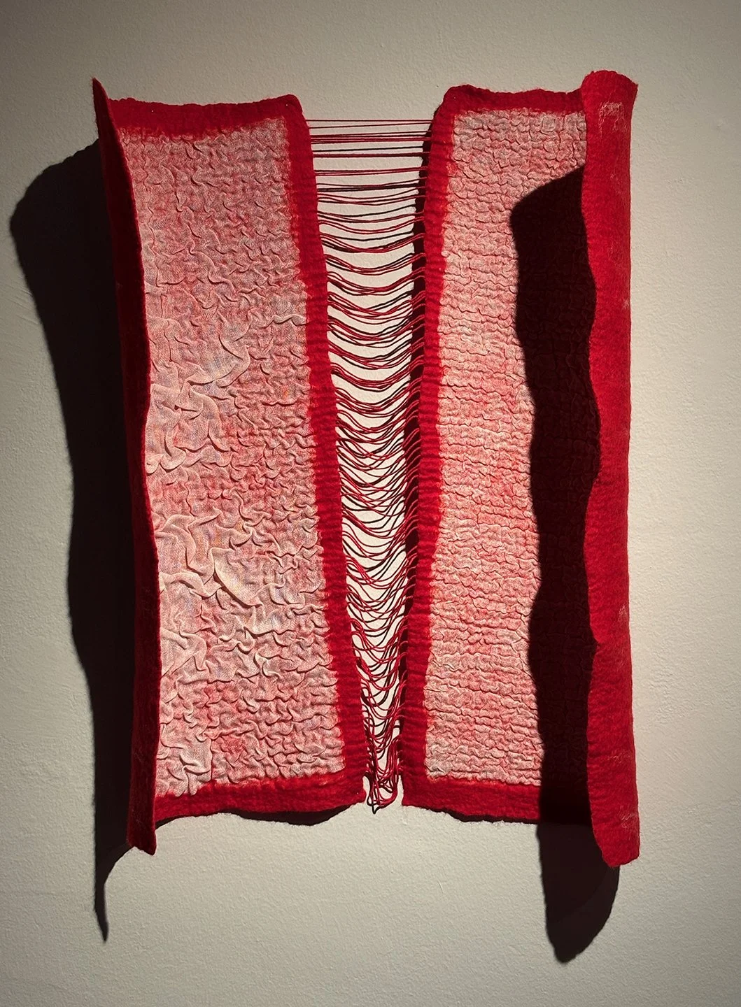 Wool and linen felted together in a technique called nuno felting.