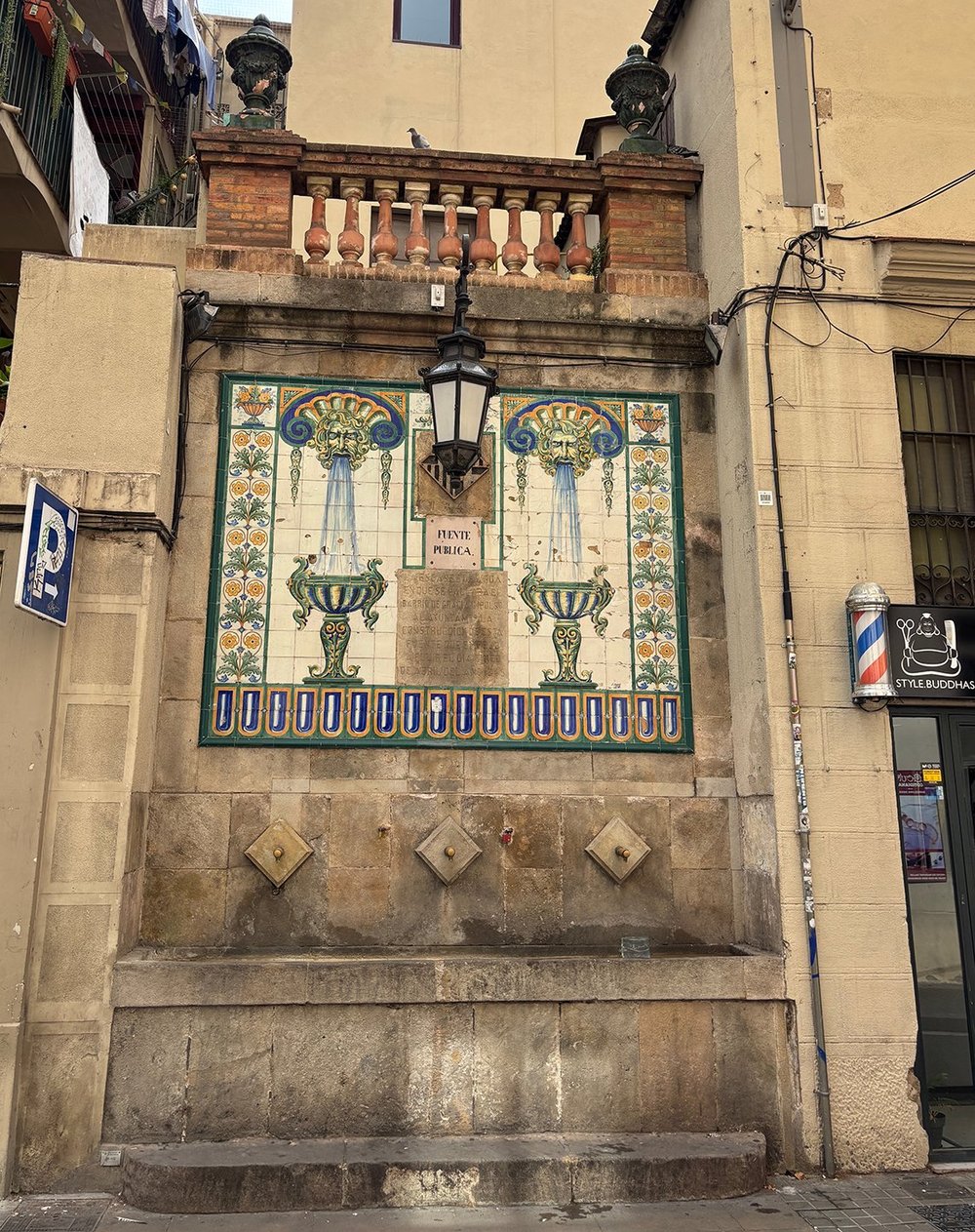 A old public water fountain in Gràcia.