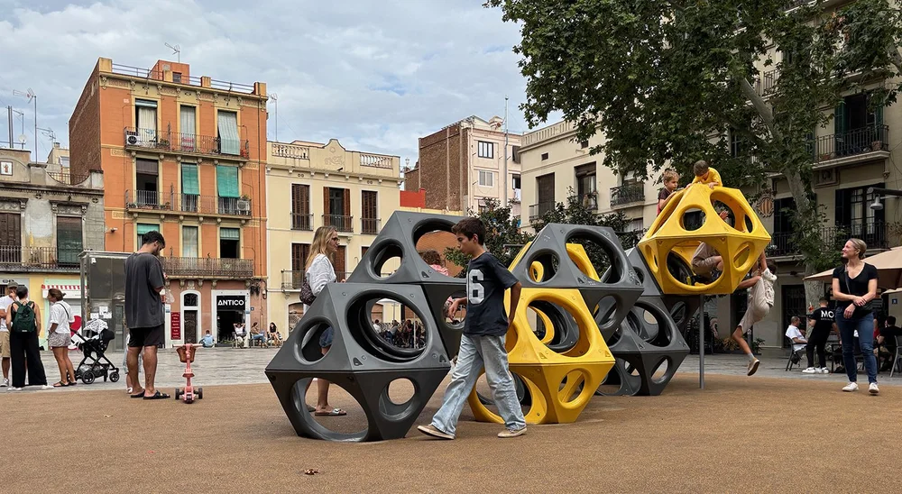 Family play time in Plaça del Sol.