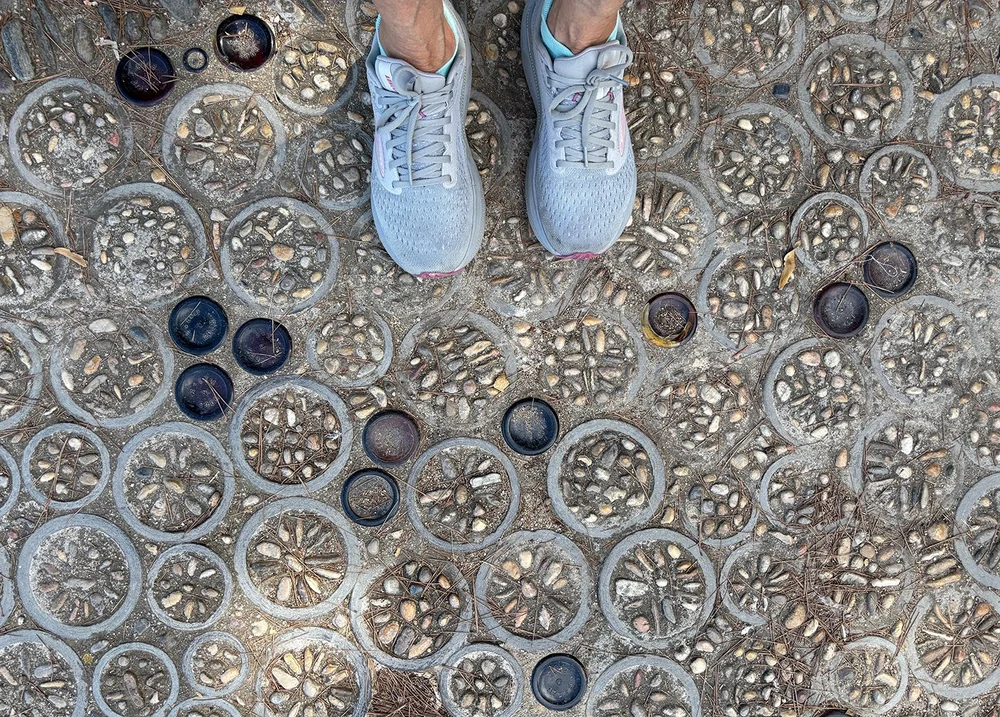 Interesting paving: pebble mosaics with bottle top and bottom rings.
