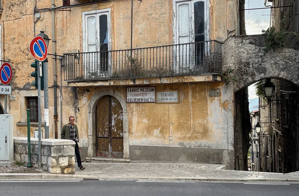Bob walking up our very tiny street, towards the main drag through town.