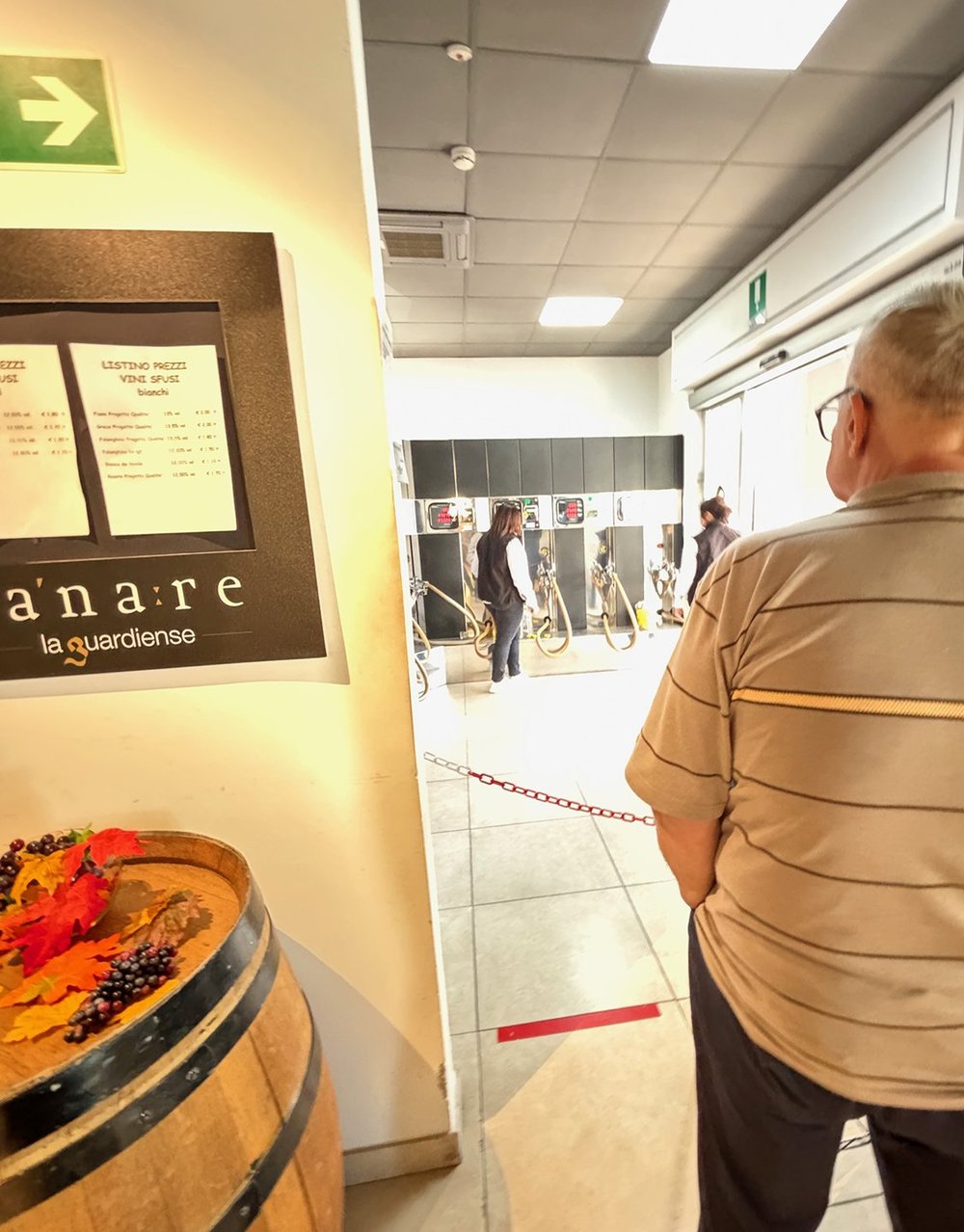 A customer waits for the gal to fill his jug.