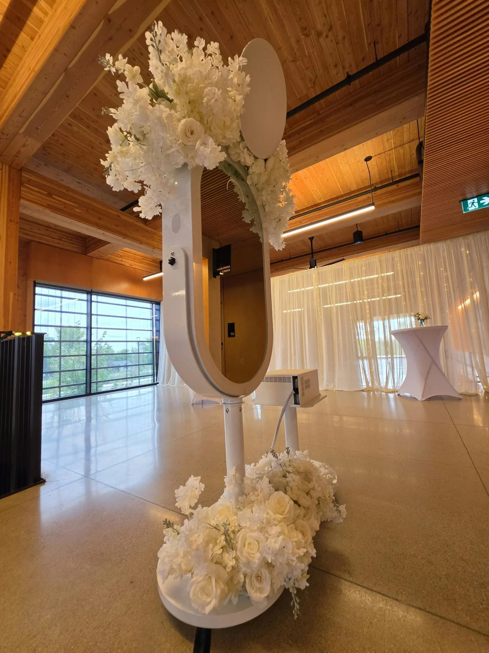 The Luxe booth dressed in white florals at the Qualico Family Centre in Winnipeg