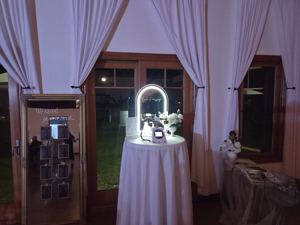 The video guest book phone station between white drapes at a Winnipeg wedding